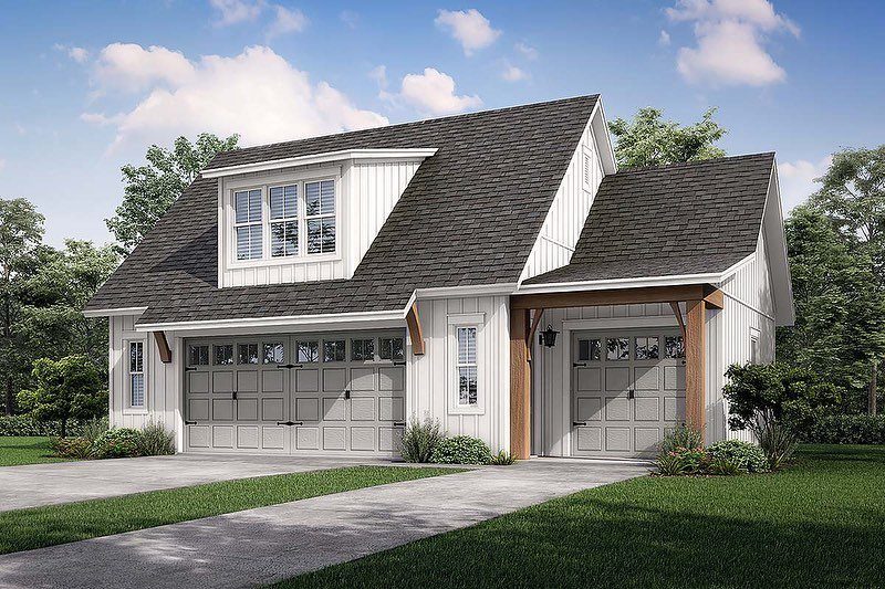 White farmhouse building with a three-car garage and an apartment located in the upper level.